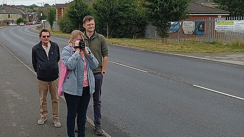 Cllrs Rob Reiss and Alan Woodcock, alongside local campaigner Susan Davidson using a speed gun.