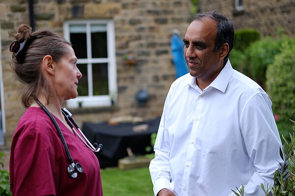 Shaffaq Mohammed talking to an NHS doctor