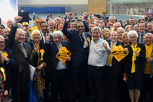 The Sheffield Lib Dem team cheering inside a sports hall